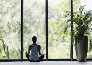 Person in peaceful meditation posture representing the guided meditation practices included in The Nervous System Reset program