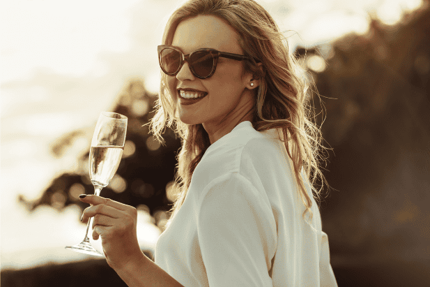 happy wealthy woman, with glass of champagne in her hand