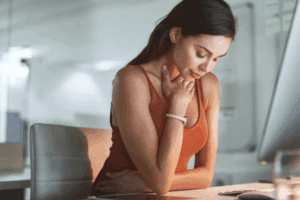 Contemplative woman with gentle expression looking inward, representing the journey of listening to your body's wisdom when feeling anxious without obvious cause