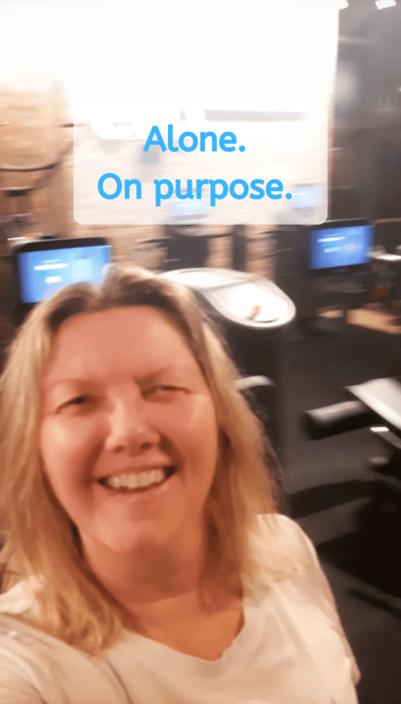 Kristina smiling in empty gym on Christmas Eve - shadow work coach choosing self-trust over people pleasing